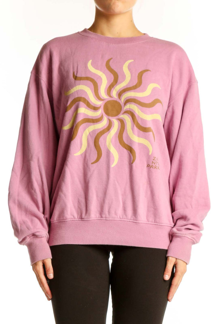 Front view of Madewell pink sweatshirt with golden sun graphic