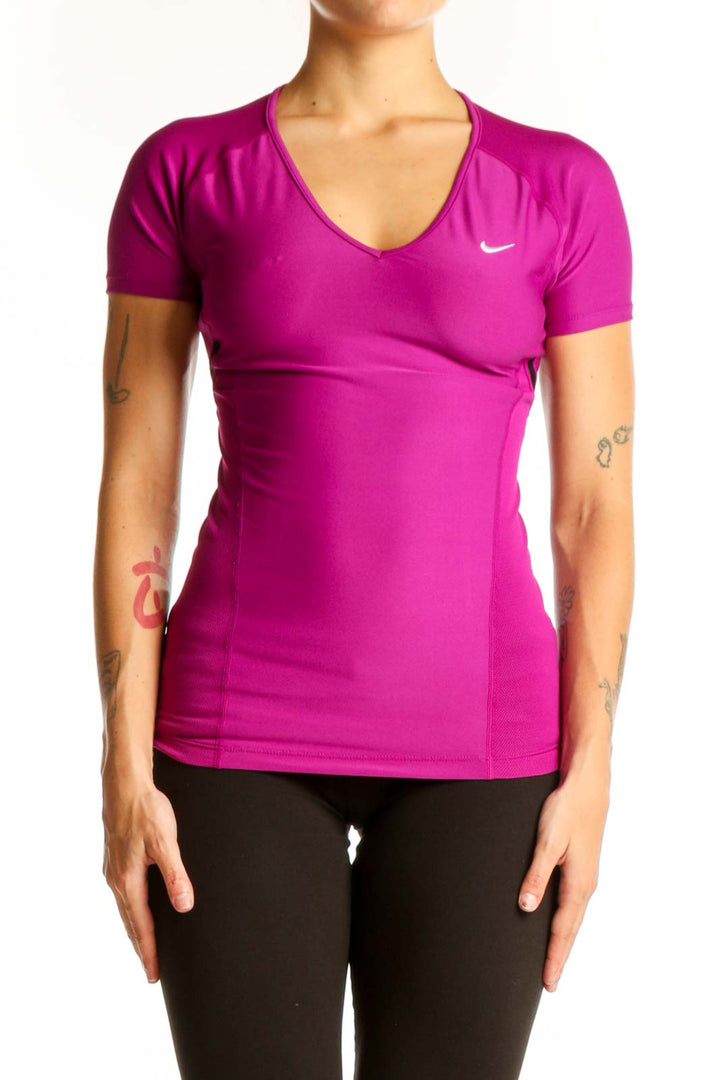 Front view of magenta Nike V-neck performance top on female model