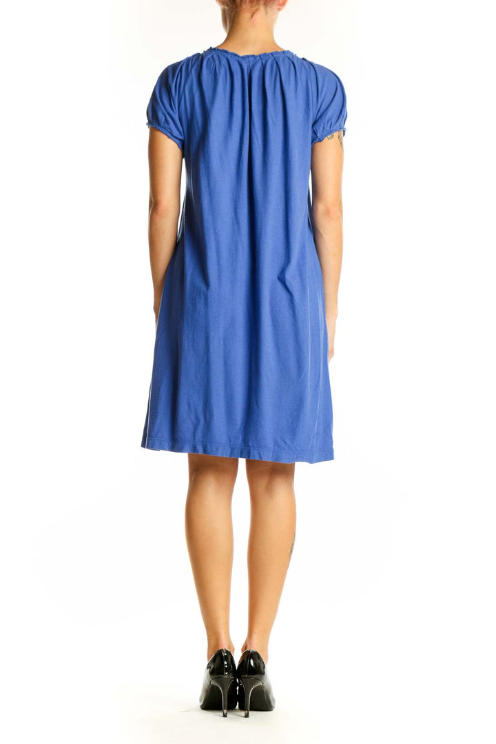 Side view of J.Crew blue flowy tunic top showing drape and length