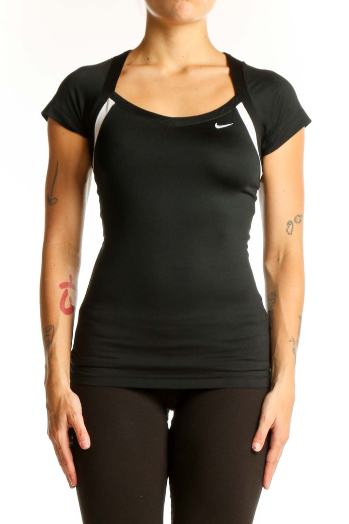 Front view of black Nike performance top with white shoulder accents