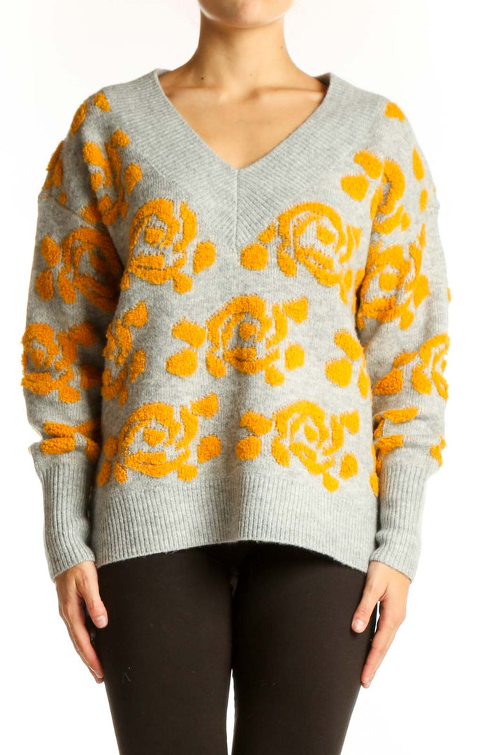 Front view of gray V-neck sweater with yellow floral pattern