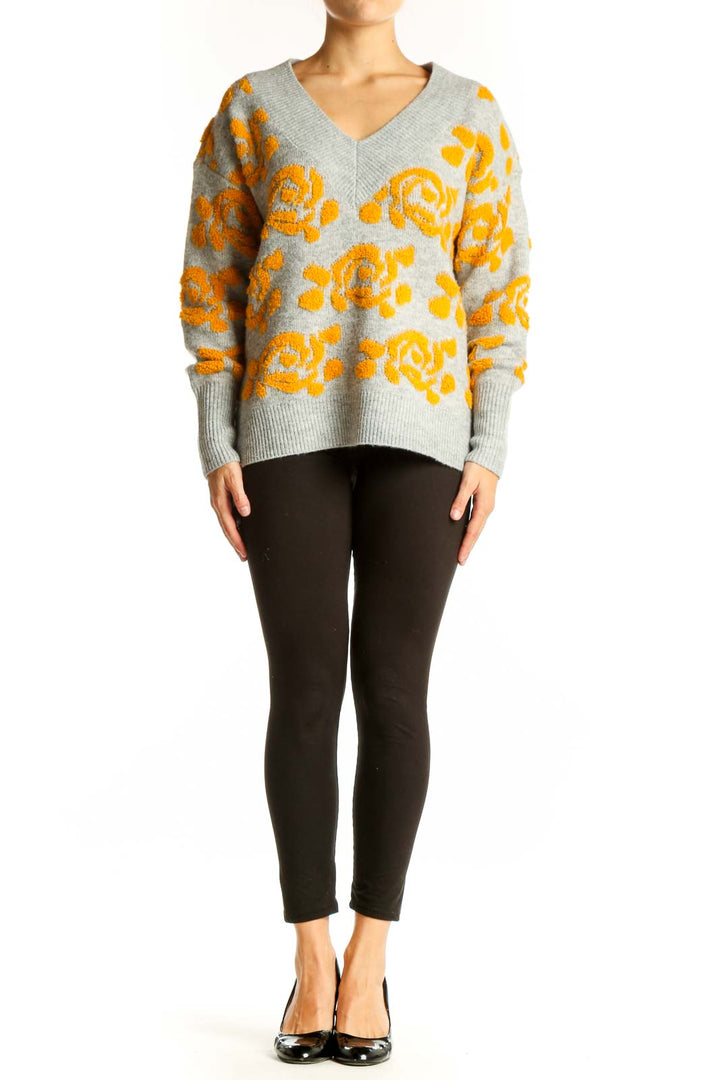 Front view of gray V-neck sweater with yellow floral pattern