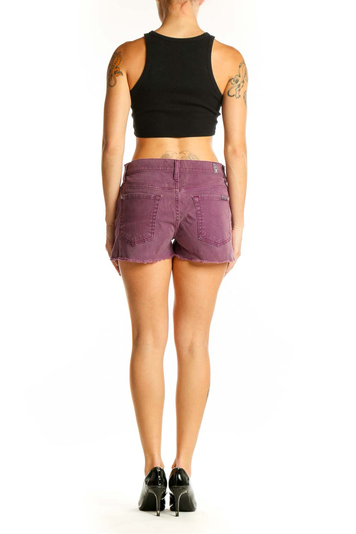 Side view of model wearing purple denim cut-off shorts by 7 For All Mankind
