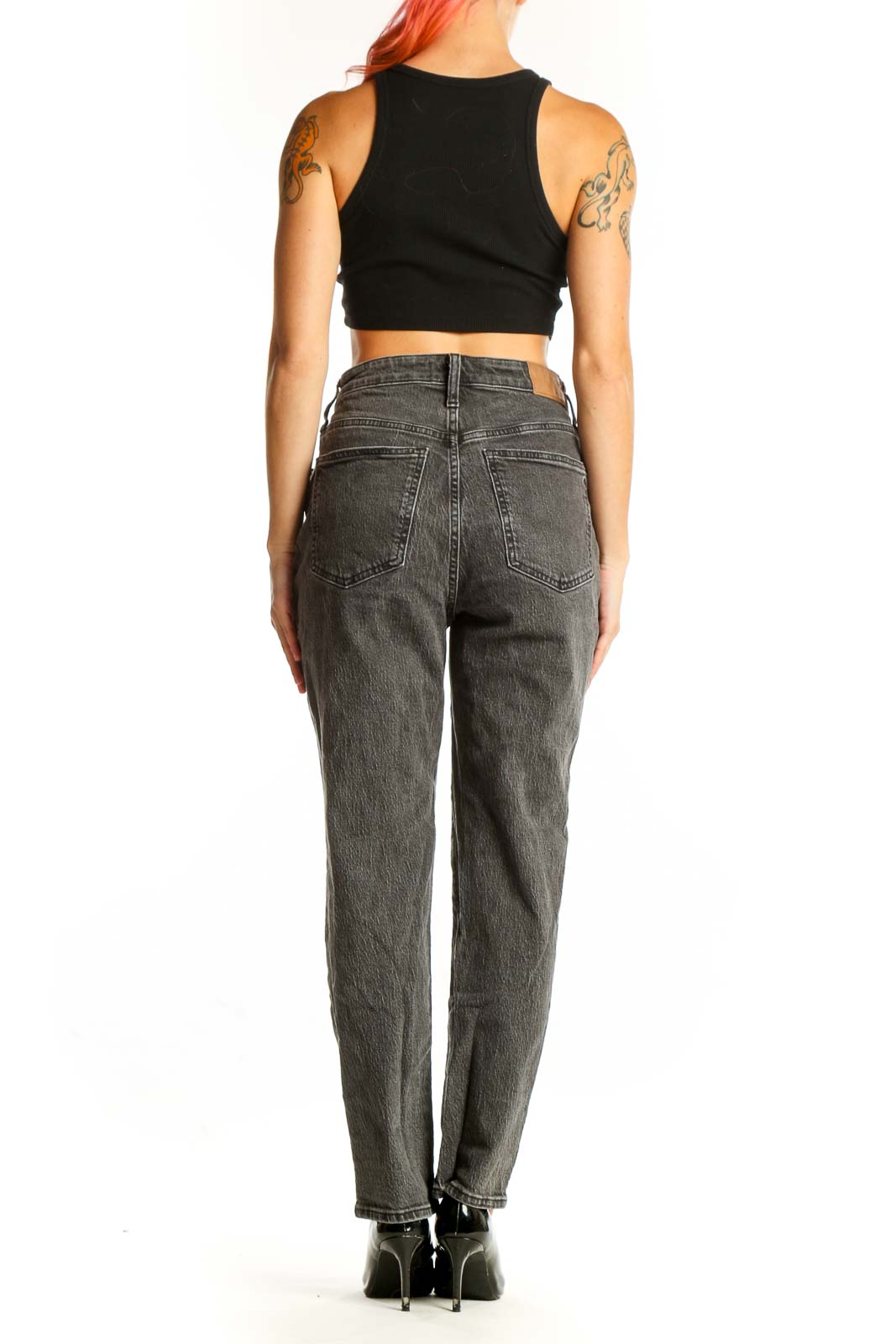 Side view of Madewell gray high-waisted straight leg jeans on model with black crop top