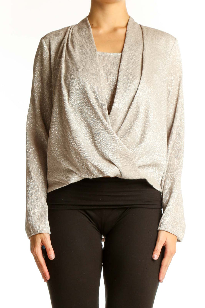 Front view of Alfani beige shimmering wrap-style blouse on model