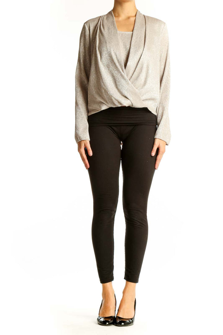 Front view of Alfani beige shimmering wrap-style blouse on model