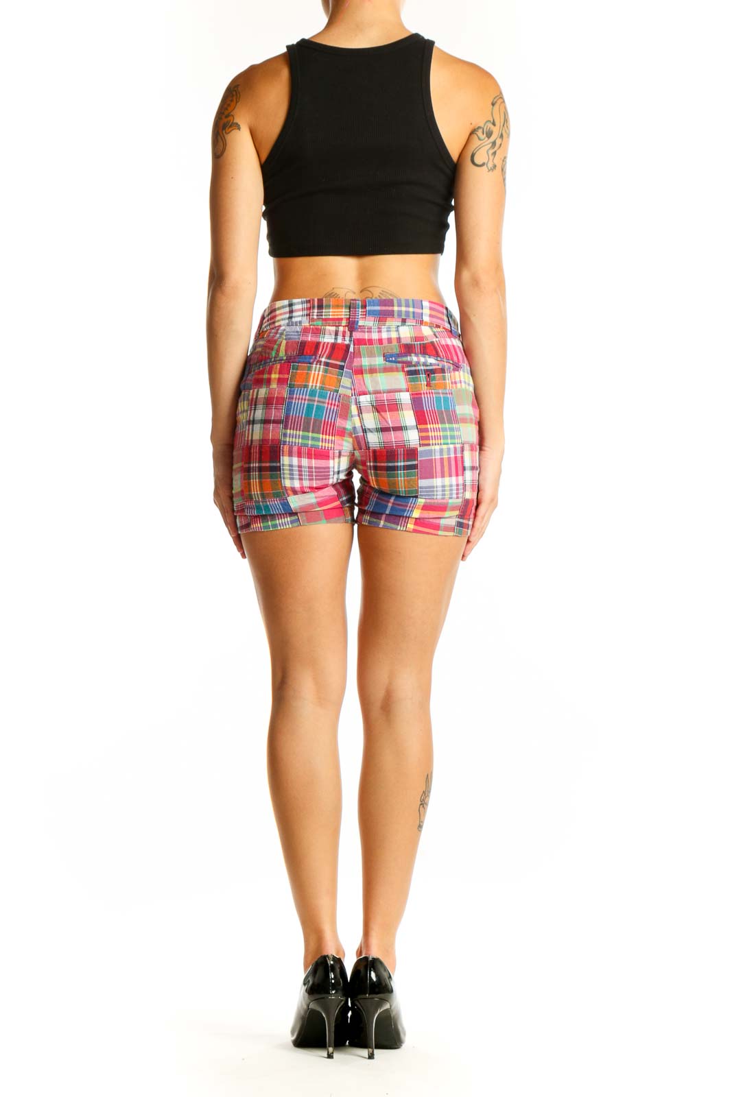 Side view of woman wearing J.Crew multicolor plaid cotton shorts with black top
