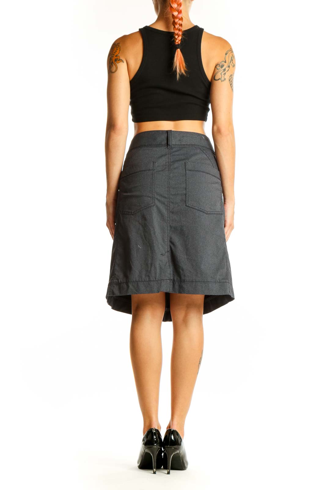 Side view of gray Athleta A-line skirt on model with black top
