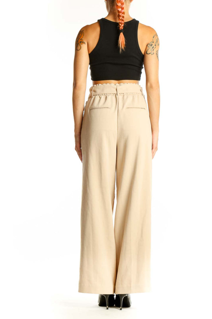 Side view of woman wearing Ann Taylor beige high-waisted wide-leg pants