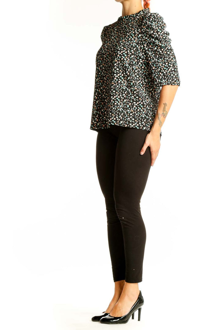 Front view of Melloday black floral print top with puff sleeves