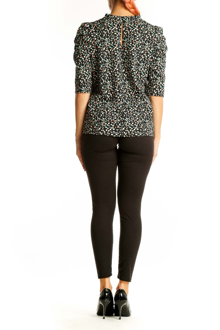 Side view of Melloday black floral print top showing puff sleeve detail