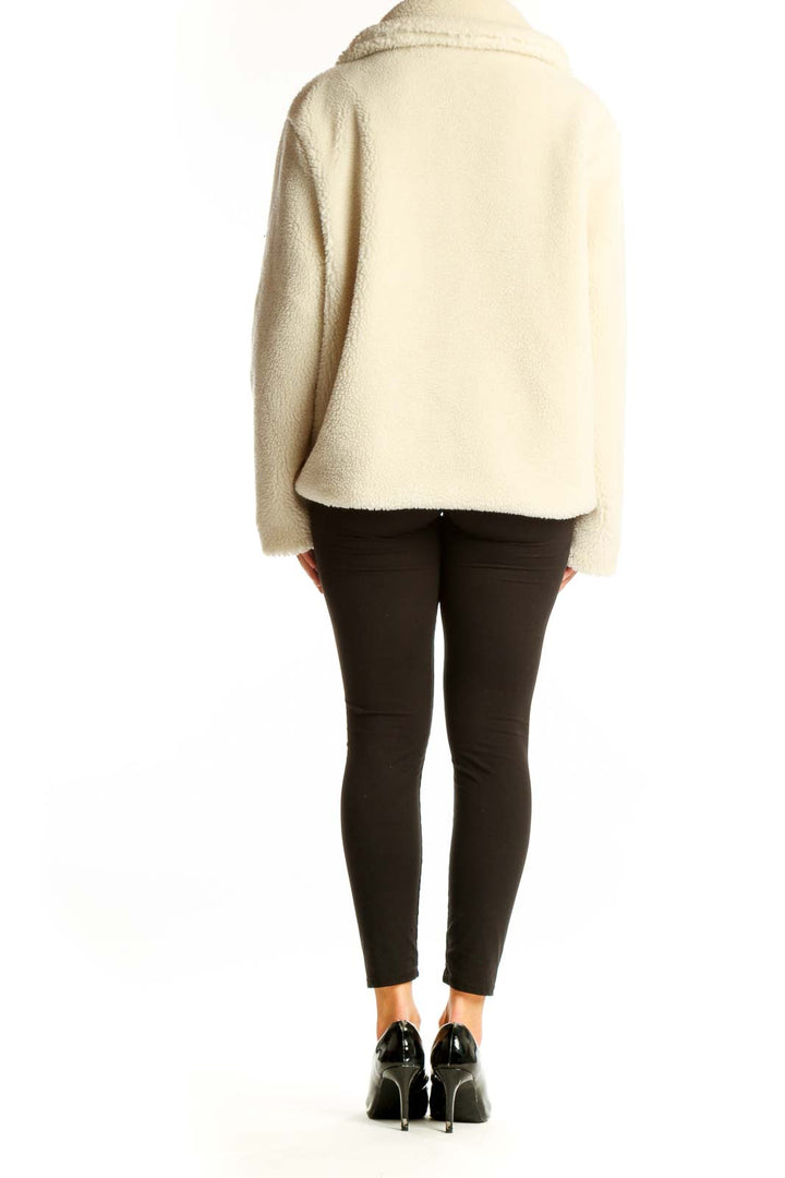Side view of cream Gap double-breasted teddy coat on model