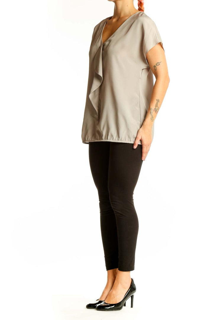 Front view of beige LOFT blouse with ruffled V-neck and short sleeves