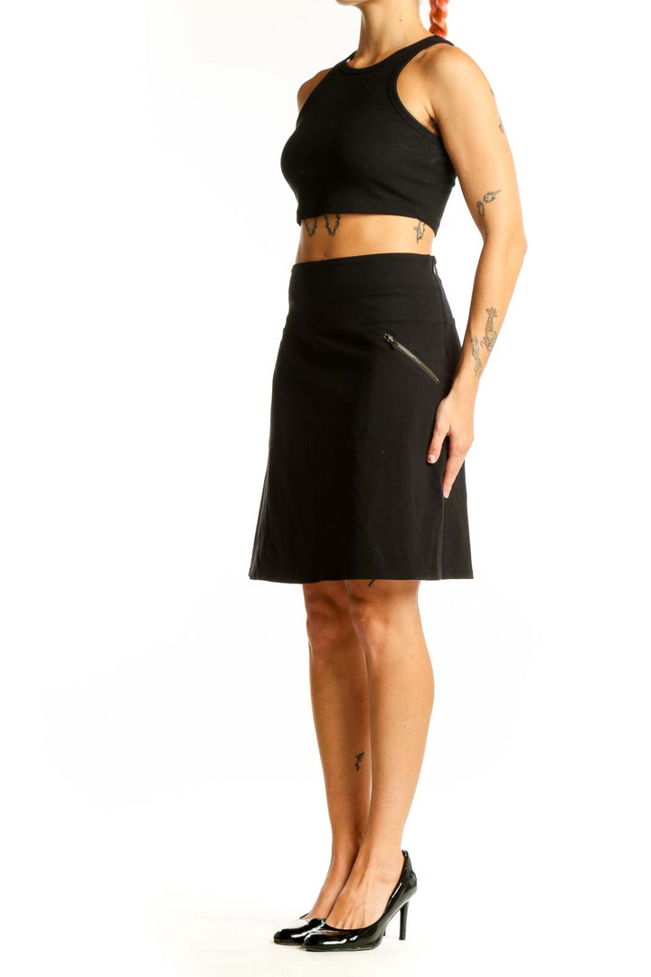 Front view of black Athleta A-line skirt with zipper pocket