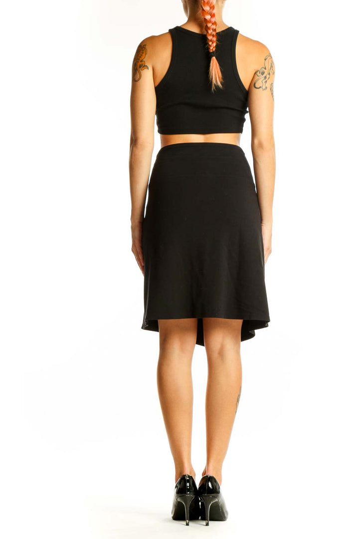 Side view of black Athleta A-line skirt on model