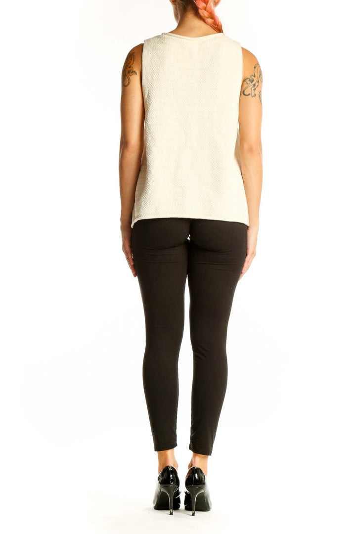 Side view of Madewell cream textured sleeveless knit top on model