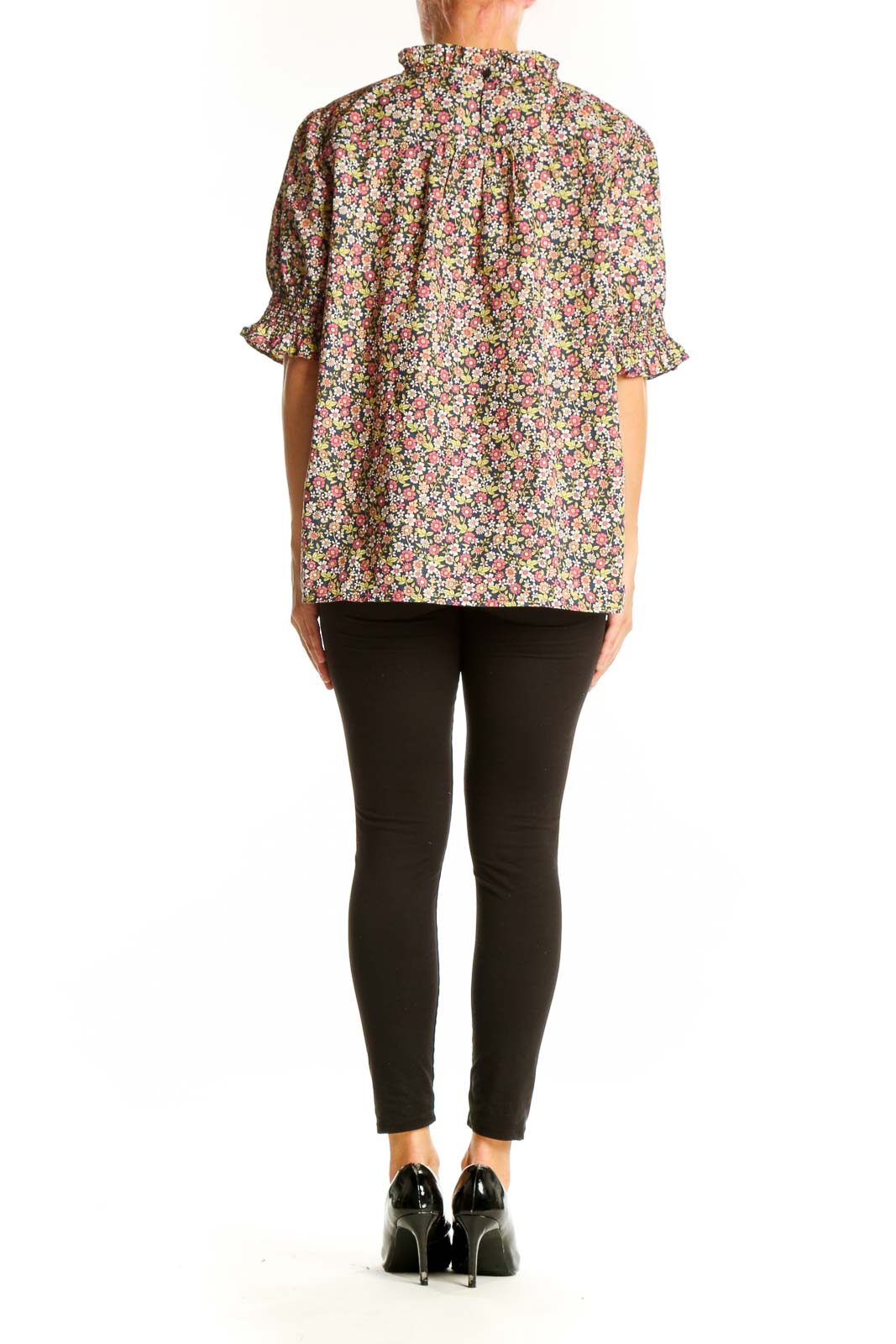 Side view of model wearing J.Crew multicolor floral puff sleeve blouse with black pants