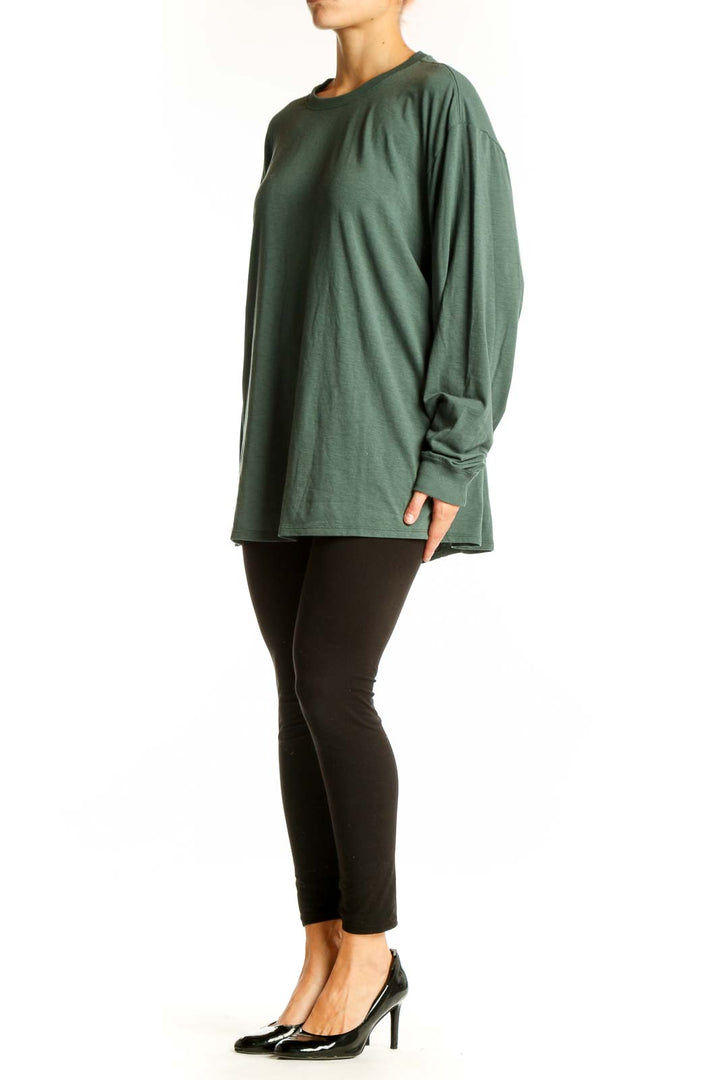 Front view of green Nike oversized long sleeve athletic top