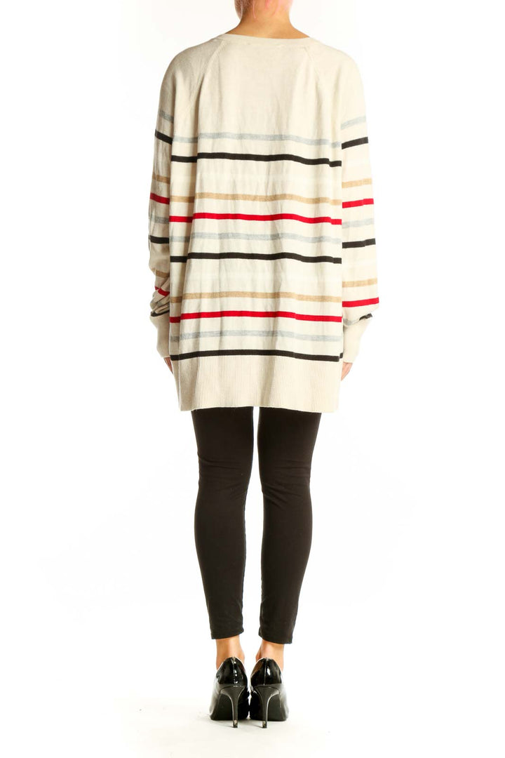 Side view of model wearing cream striped V-neck oversized sweater from LOFT