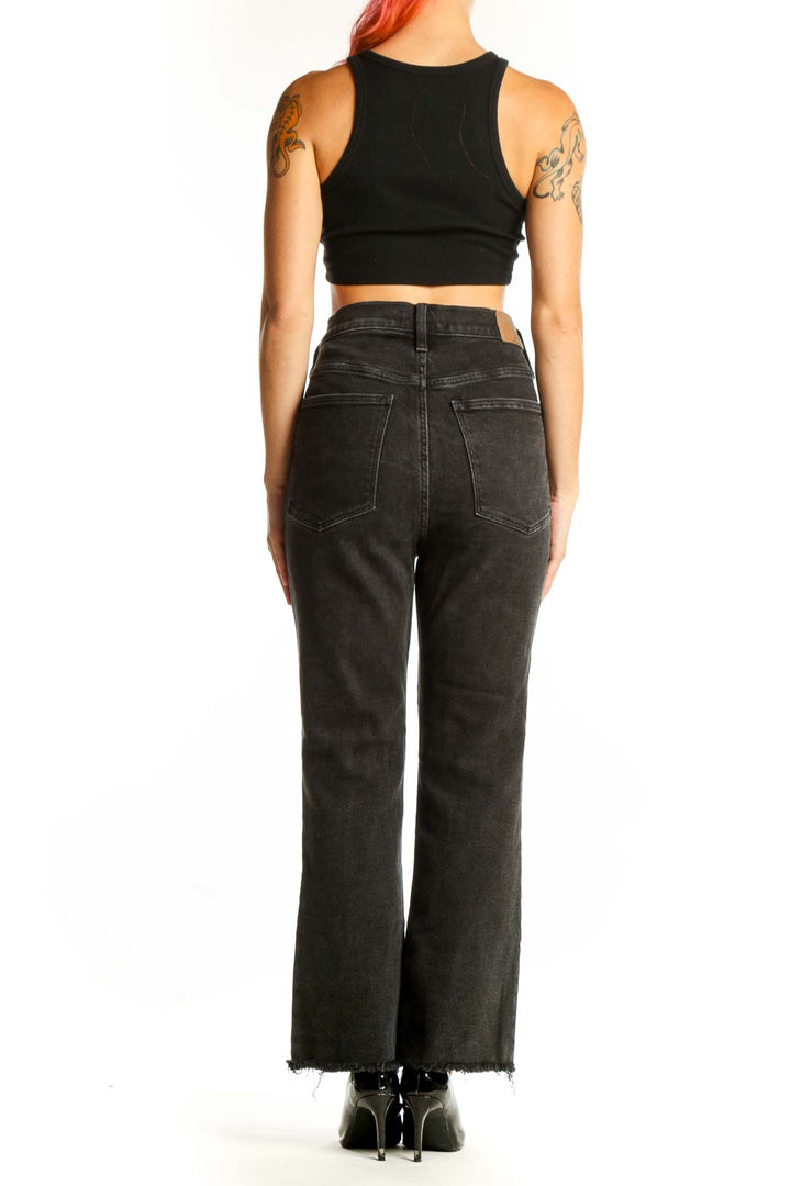 Side view of model wearing Madewell black high-waisted wide-leg jeans