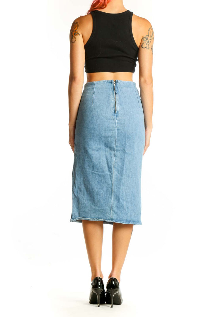 Side view of J.Crew light blue denim midi pencil skirt with black crop top