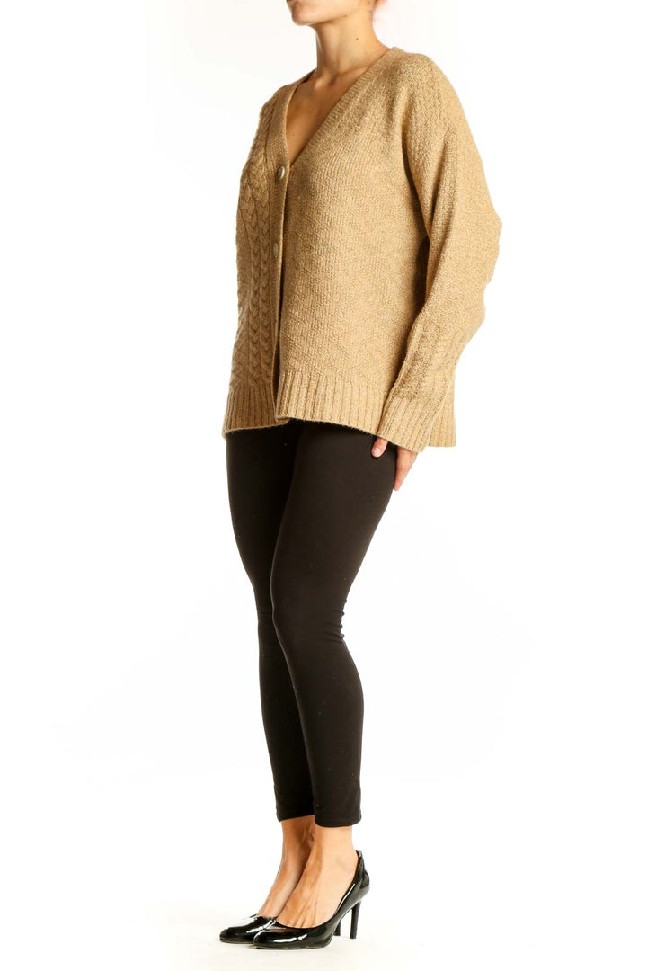 Front view of Cabi camel cable knit V-neck cardigan