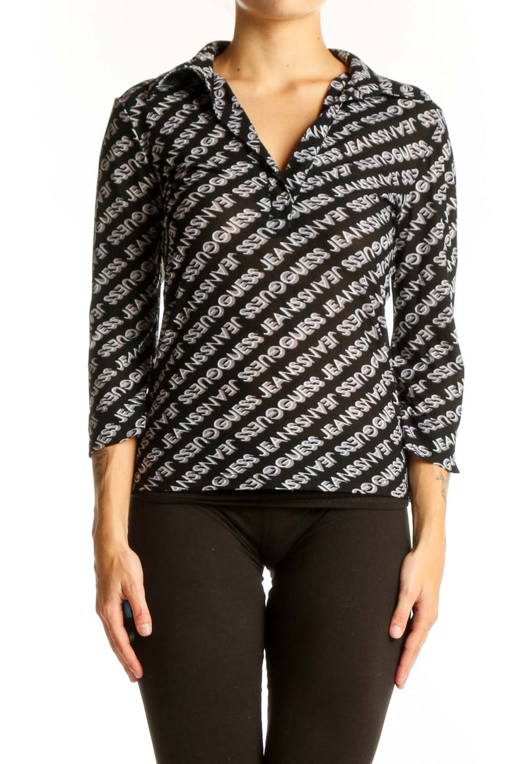 Front view of Guess black and white logo patterned wrap top