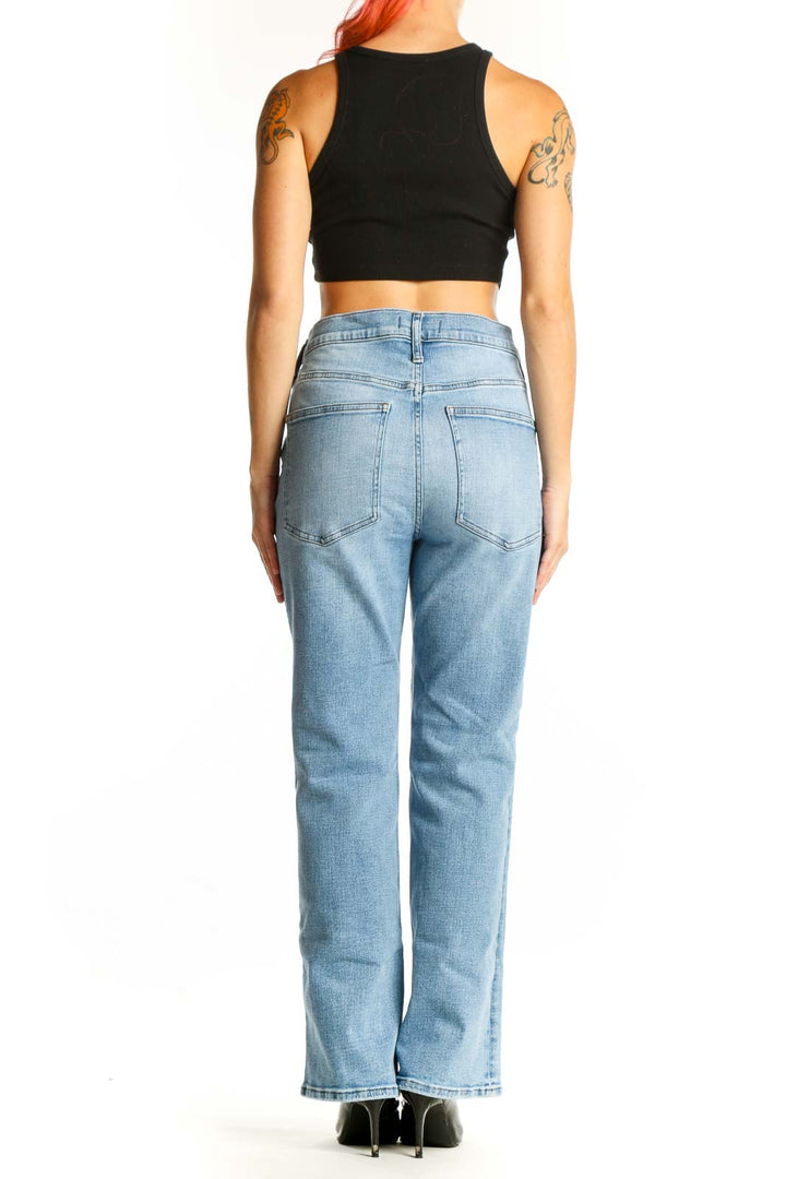 Side view of woman wearing Madewell light blue high-waisted straight-leg jeans