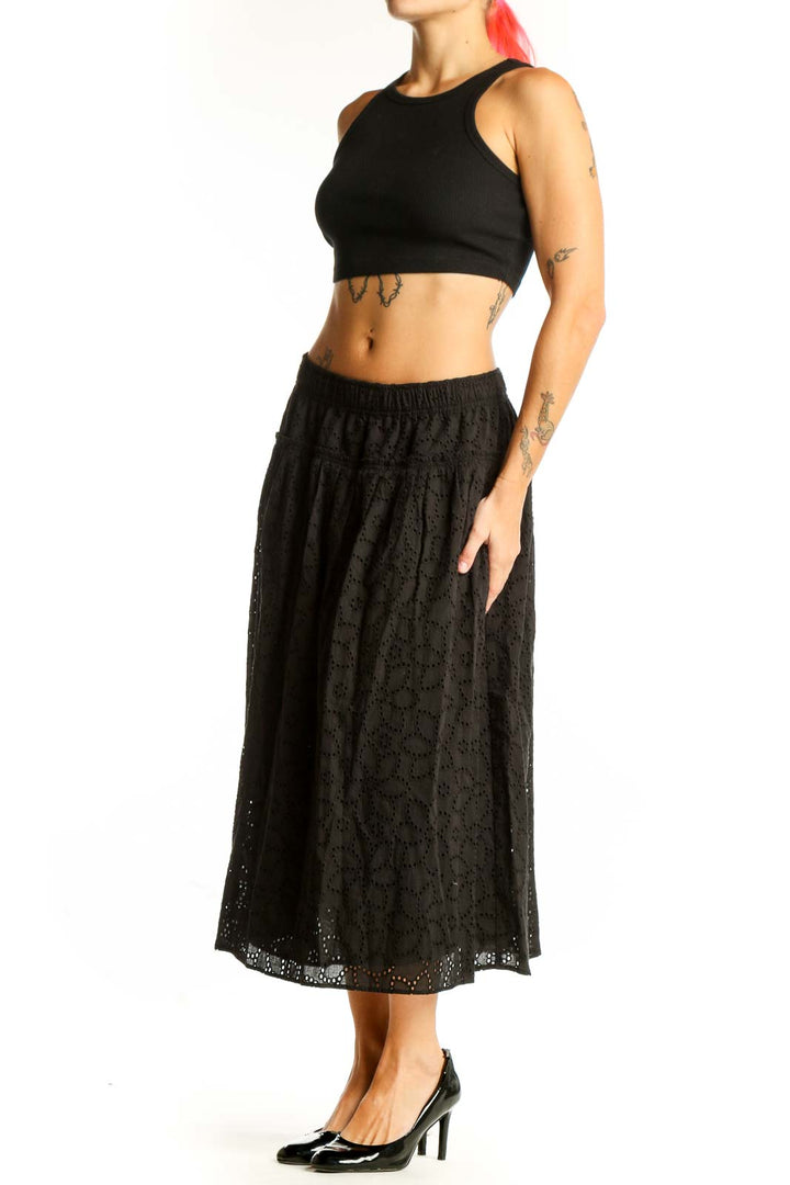 Front view of Madewell black eyelet lace cotton midi skirt