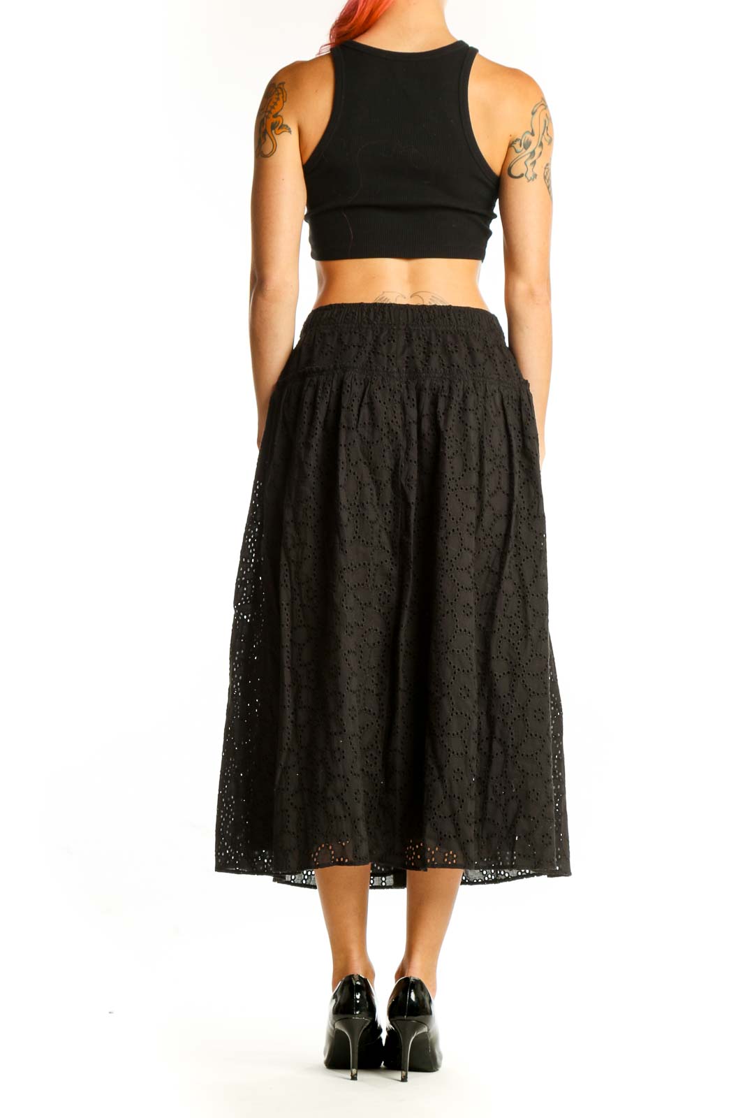 Side view of model wearing Madewell black eyelet lace cotton midi skirt