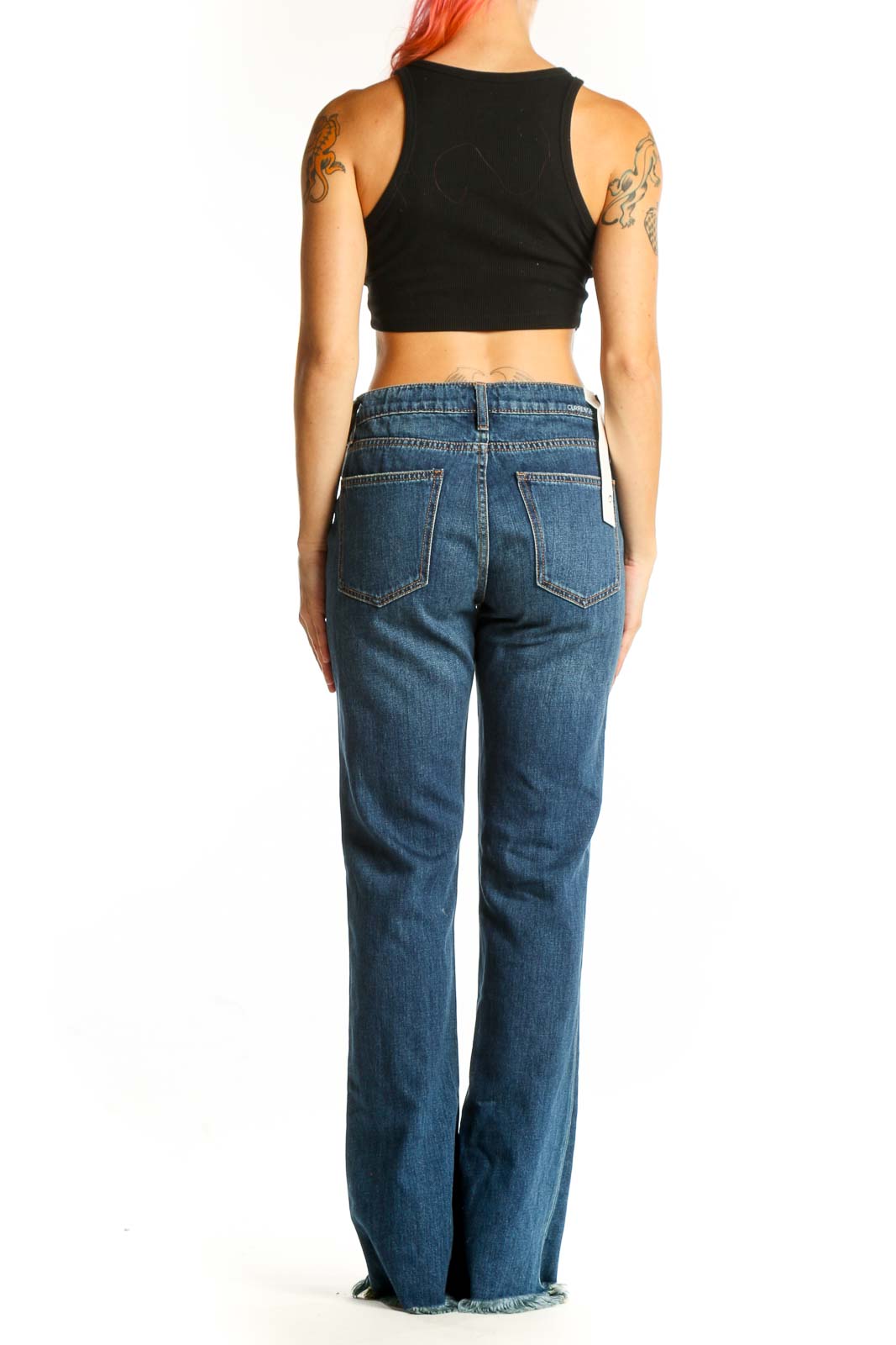 Side view of model wearing C/E Current/Elliott blue wide-leg jeans