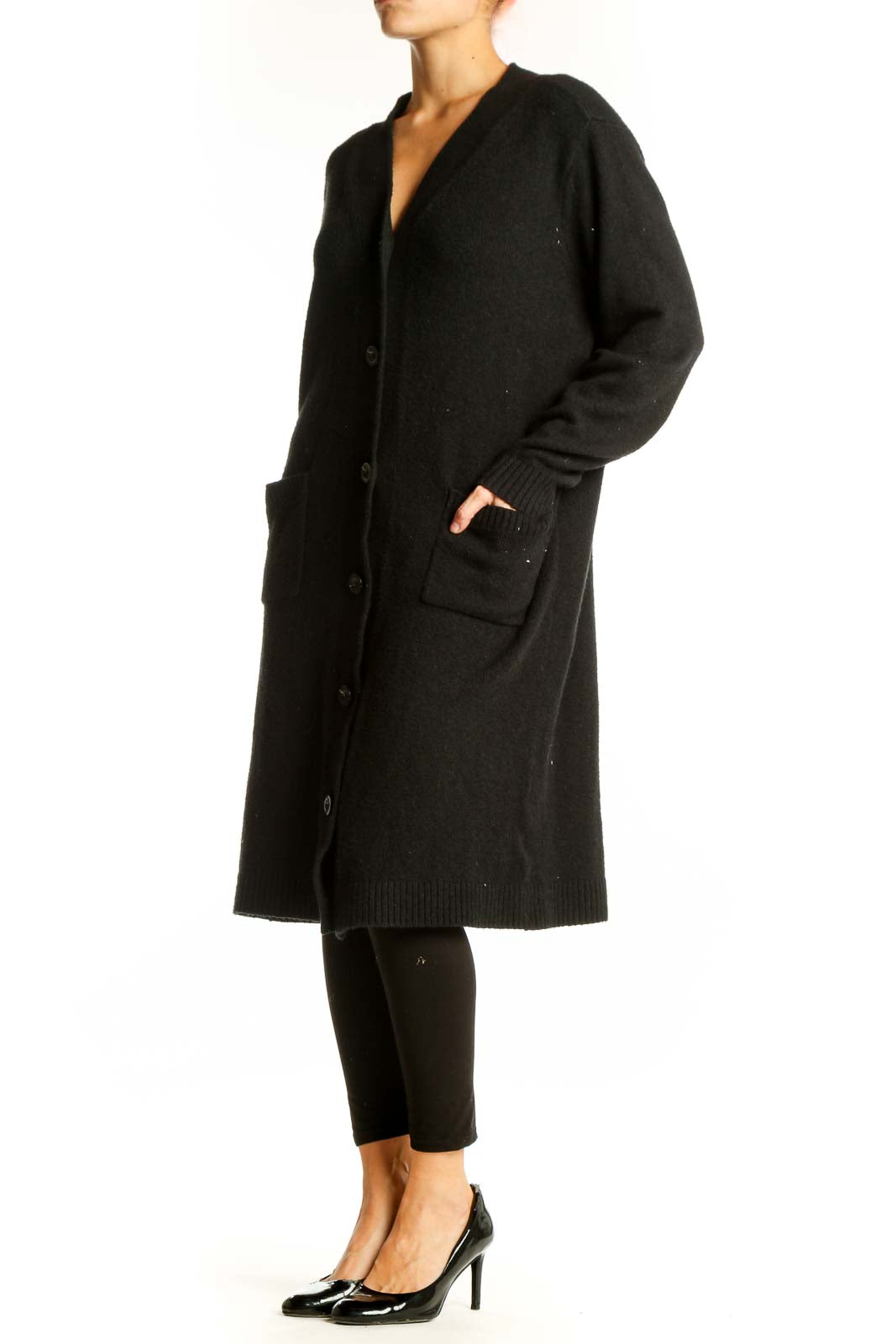 Front view of Cabi black long button-up cardigan on model