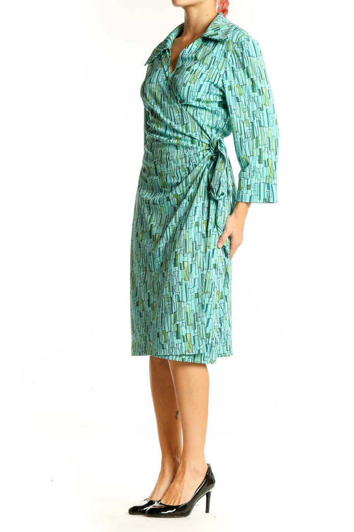 Front view of DANI-MAX teal geometric print wrap dress with long sleeves
