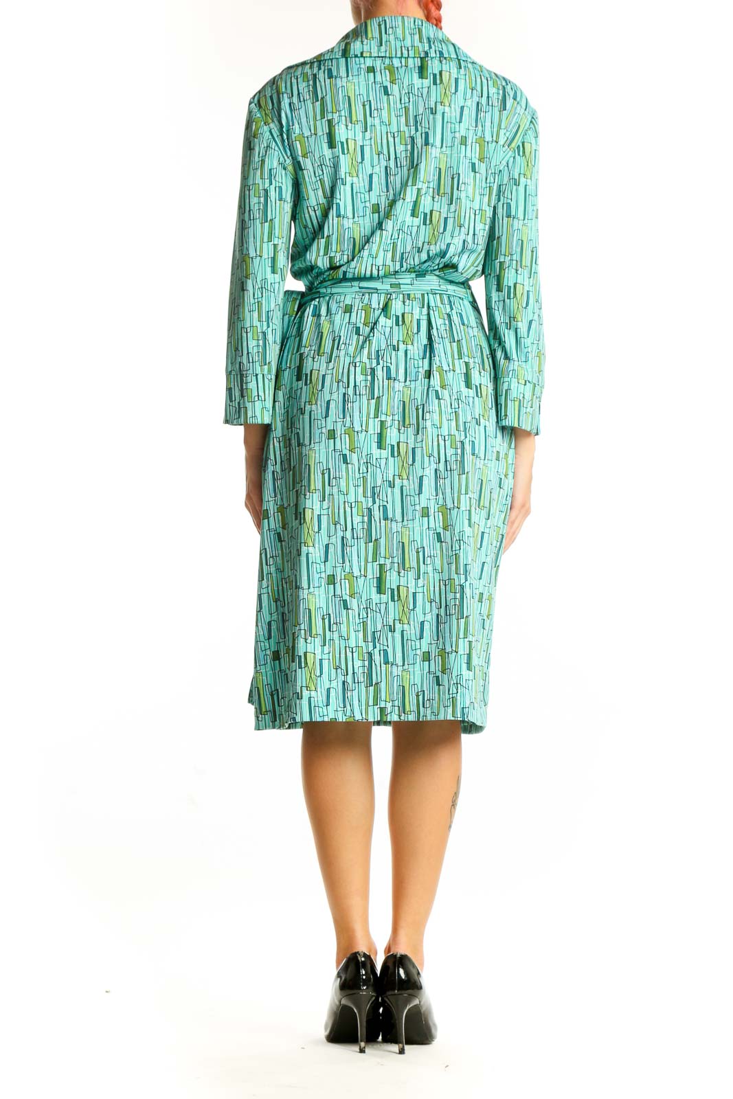 Side view of DANI-MAX teal geometric print wrap dress showing tie closure