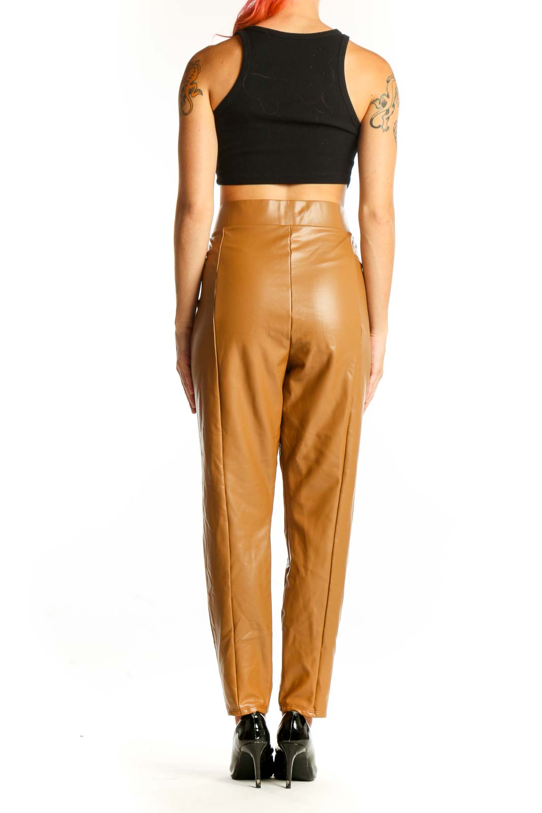 Side view of model wearing LOFT camel faux leather pants with black crop top
