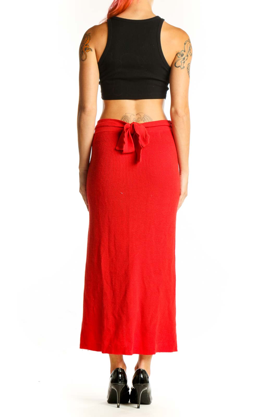 Side view of red ribbed knit maxi skirt showing high slit