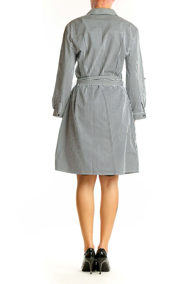 Side view of Mango black and white striped cotton shirt dress showing belted waist