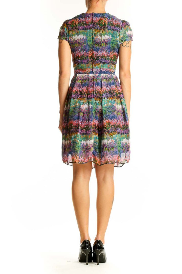 Side view of Dorothy Perkins multicolor floral print pleated dress showing silhouette