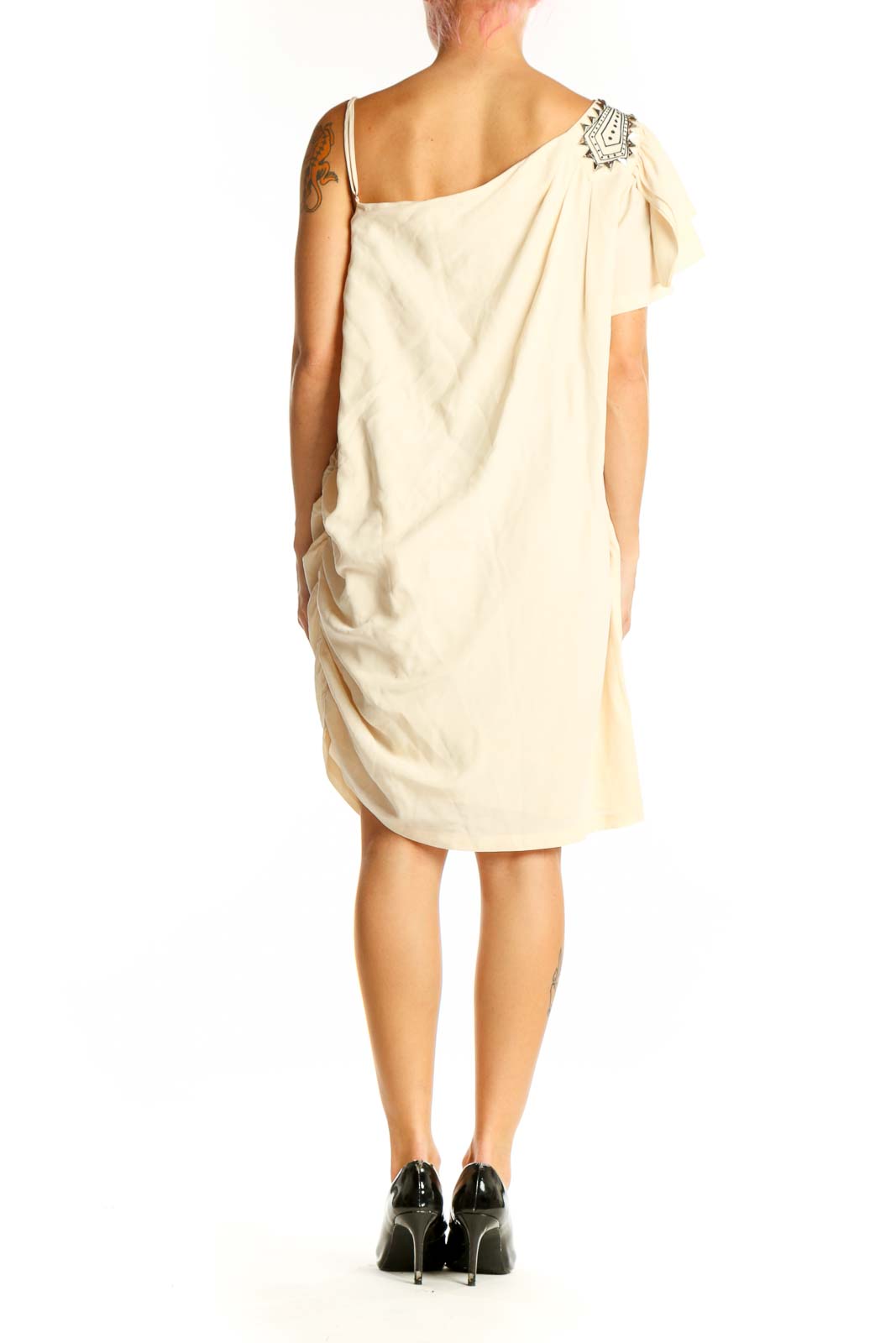 Side view of cream one-shoulder cocktail dress showing drape and fit