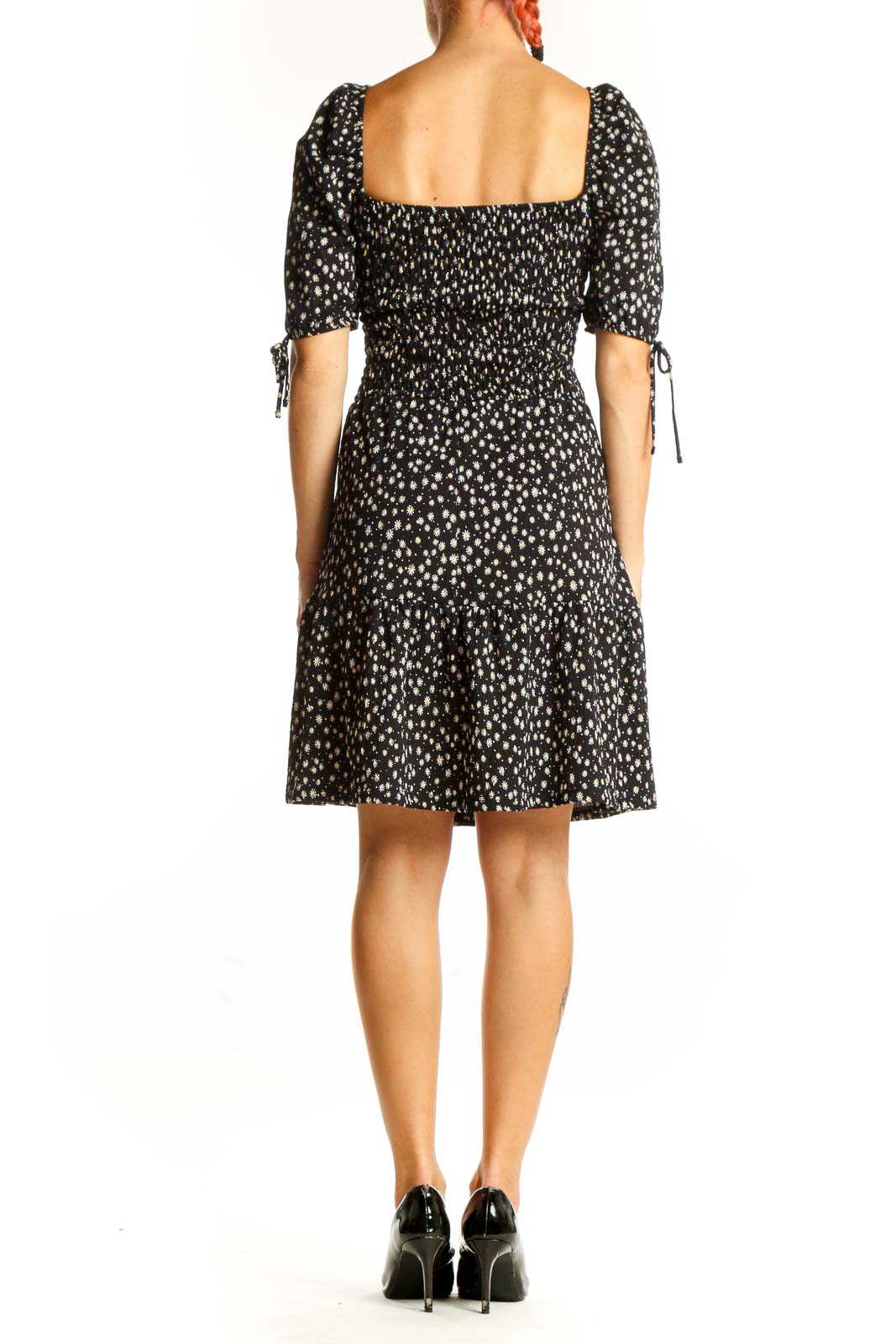 Side view of Topshop black floral print dress showing smocked bodice and midi length