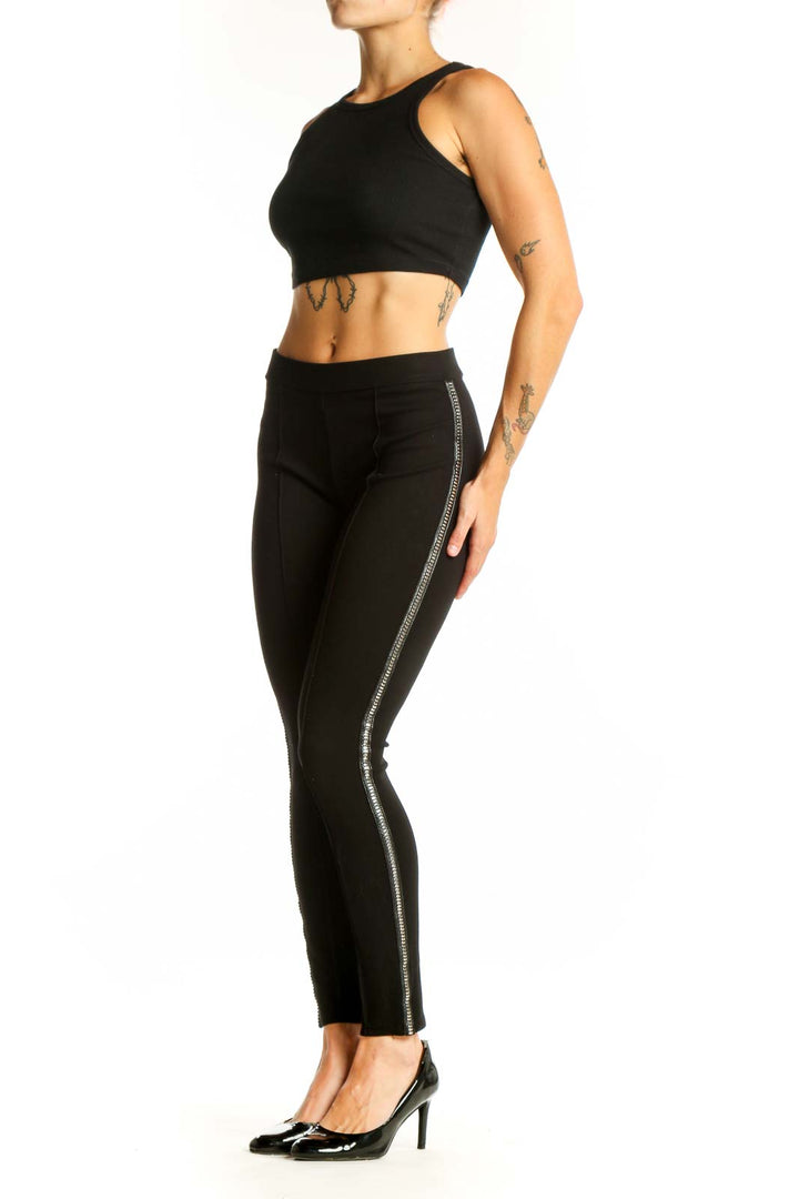 Front view of black fitted pants with metallic side stripes by Romeo & Juliet Couture