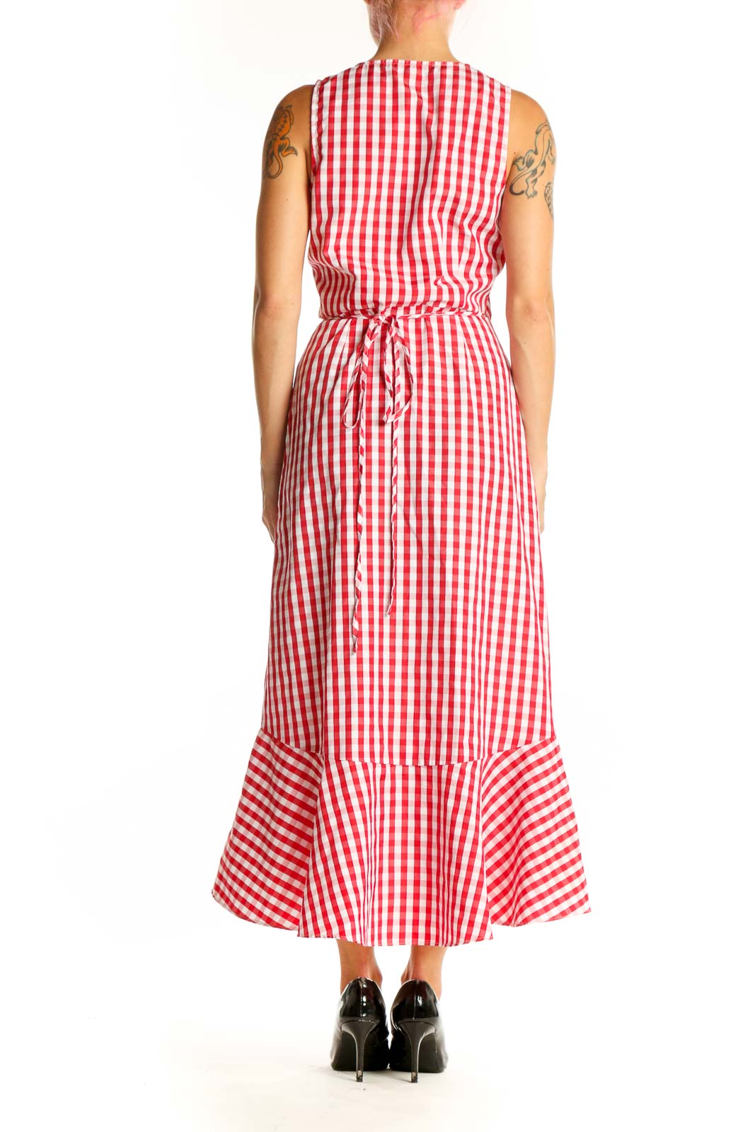 Side view of red and white gingham wrap midi dress showing high-low hemline and sleeveless design