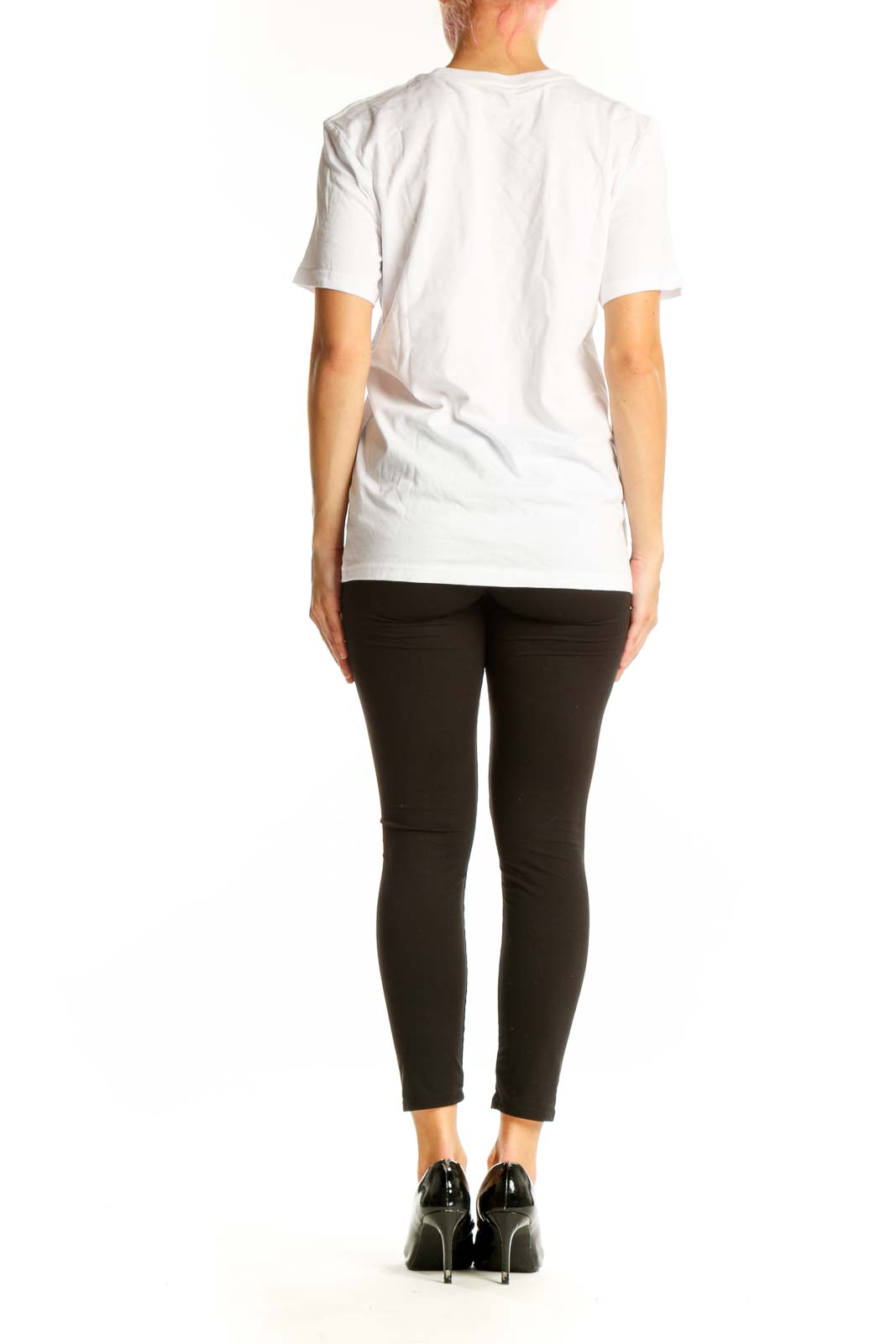 Side view of model wearing white Adidas graphic t-shirt with black pants