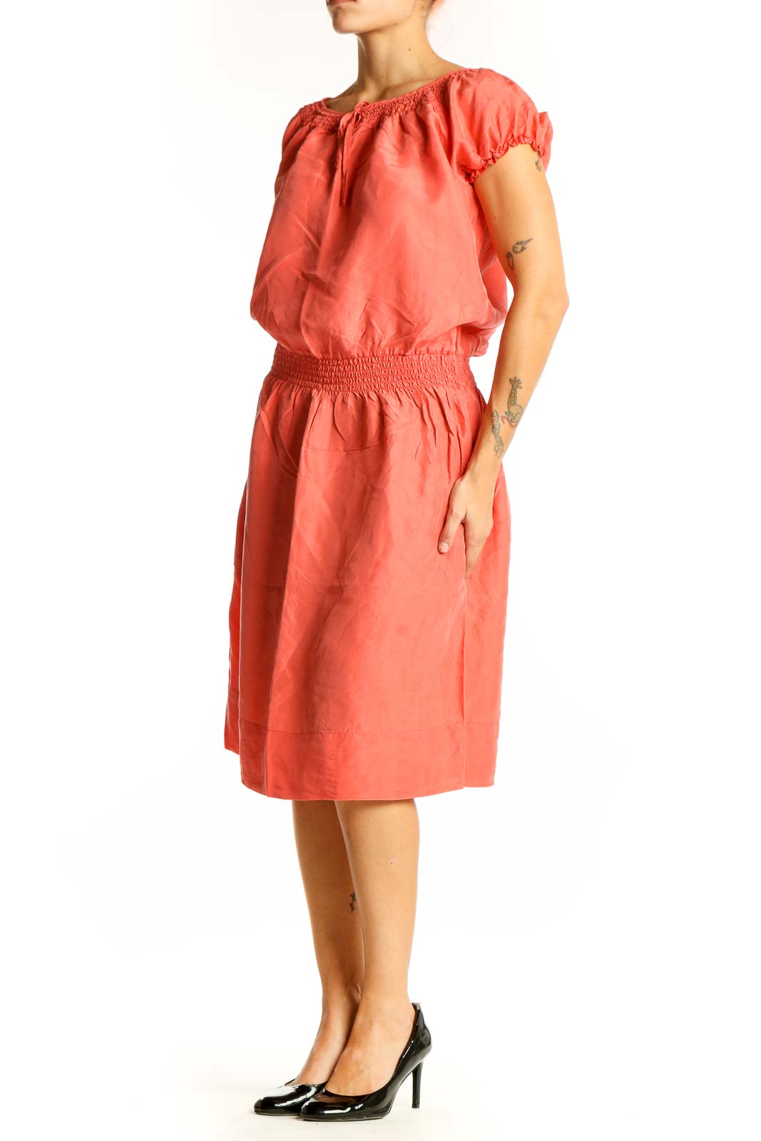 Front view of coral silk peasant dress with puff sleeves and smocked waist