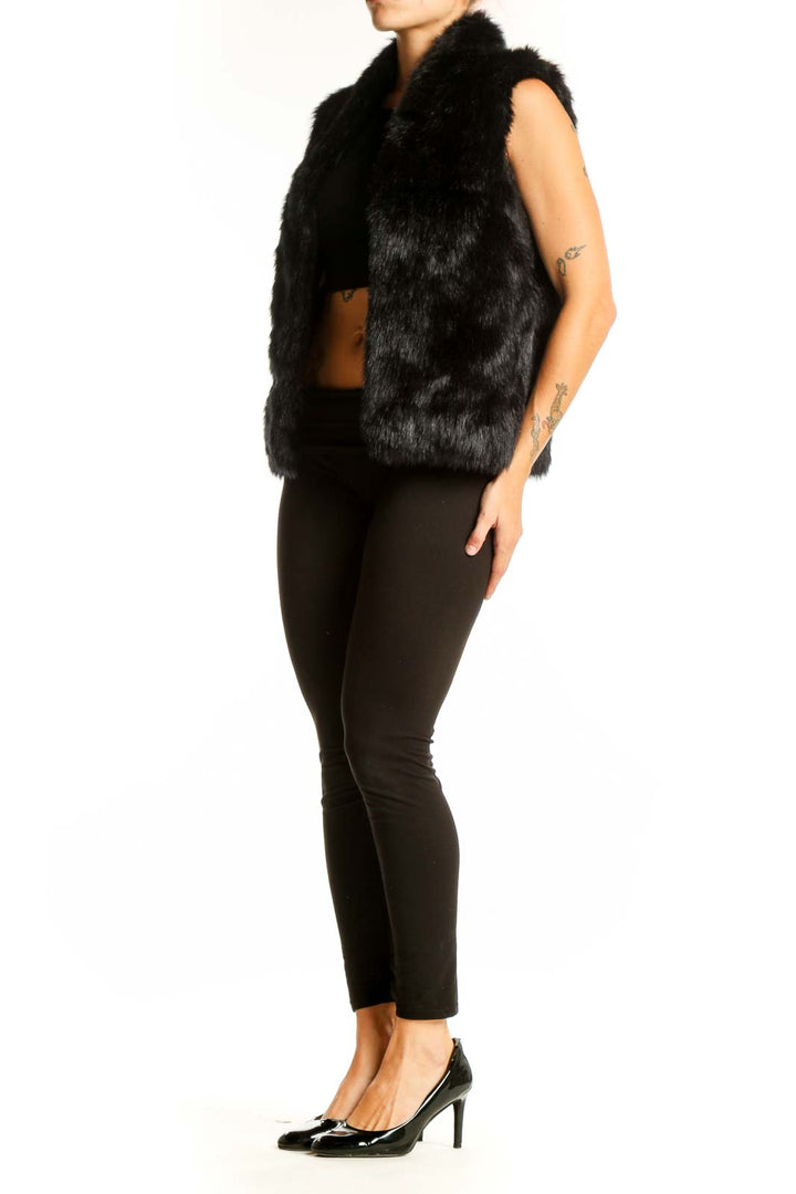 Front view of black faux fur sleeveless vest from Express