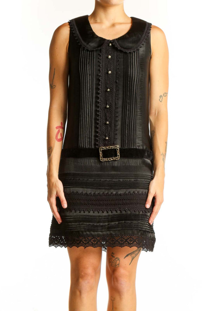Front view of Anna Sui black vintage-inspired dress with lace trim and pintuck details