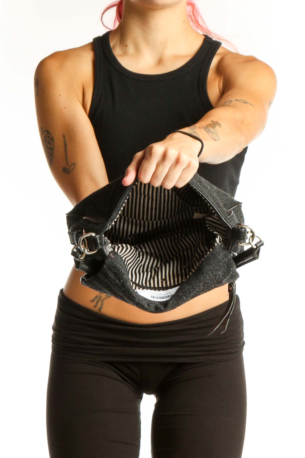 Side view of Kate Spade black crossbody bag worn by model