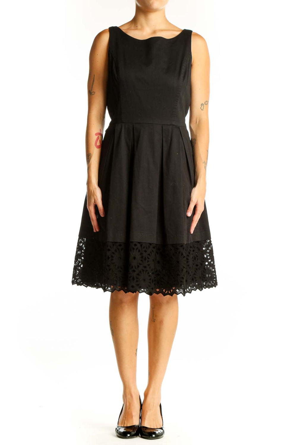 Front view of black sleeveless dress with pleated skirt and lace hem