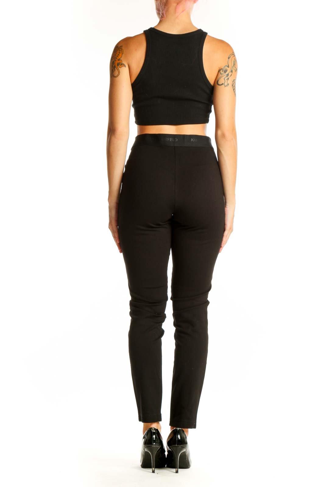 Back view of model wearing Karl Lagerfeld black faux leather pants with crop top