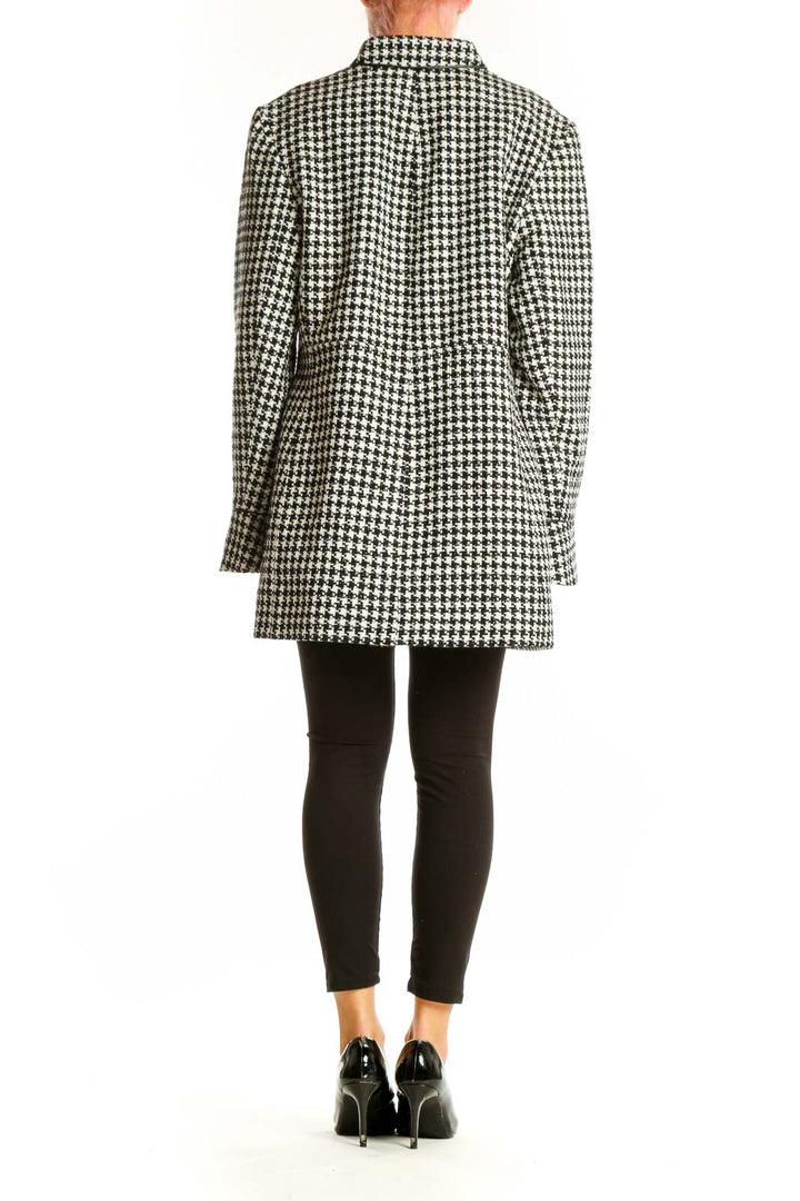 Side view of The Limited black and white houndstooth oversized jacket on model